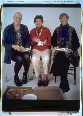 All 3, seated, with pizza